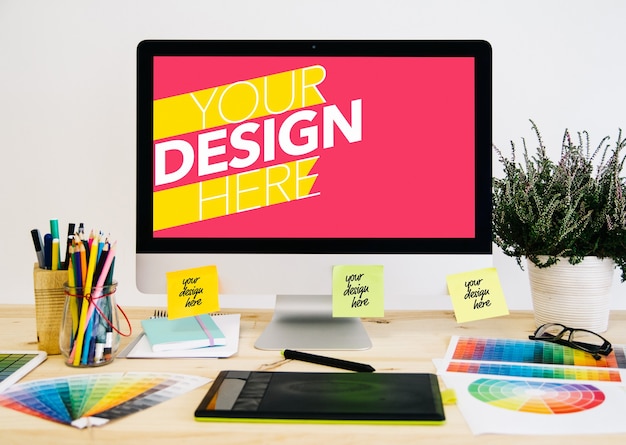 Computador e papéis na simulação de desktop de design gráfico