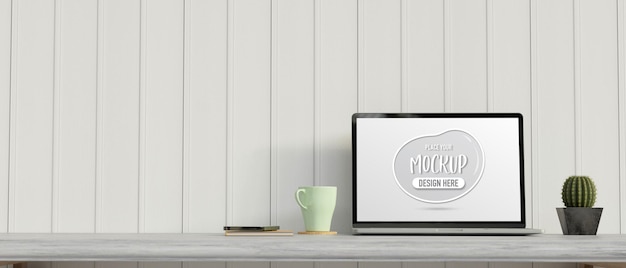 computer portatile con schermo mockup sulla scrivania con vaso di cactus e tazza