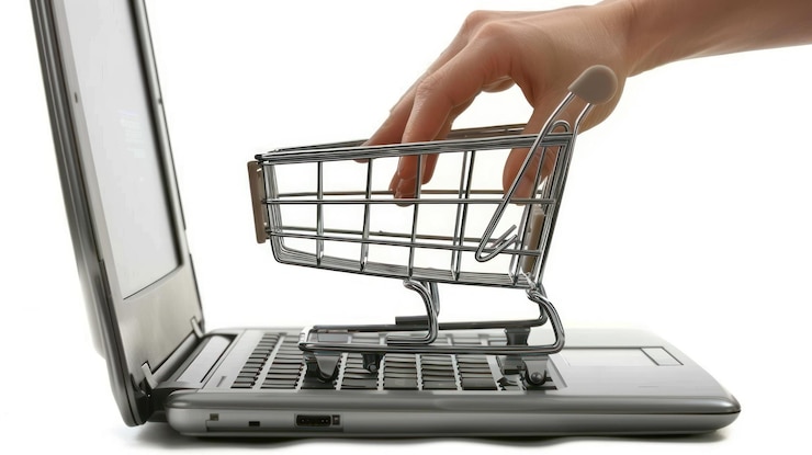 PSD concepto de compras en línea de colocación manual de un carrito de compras en miniatura en el teclado de la computadora portátil