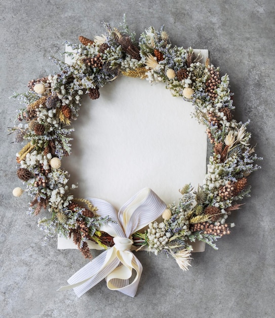 Corona de flores sobre una maqueta de tarjeta blanca