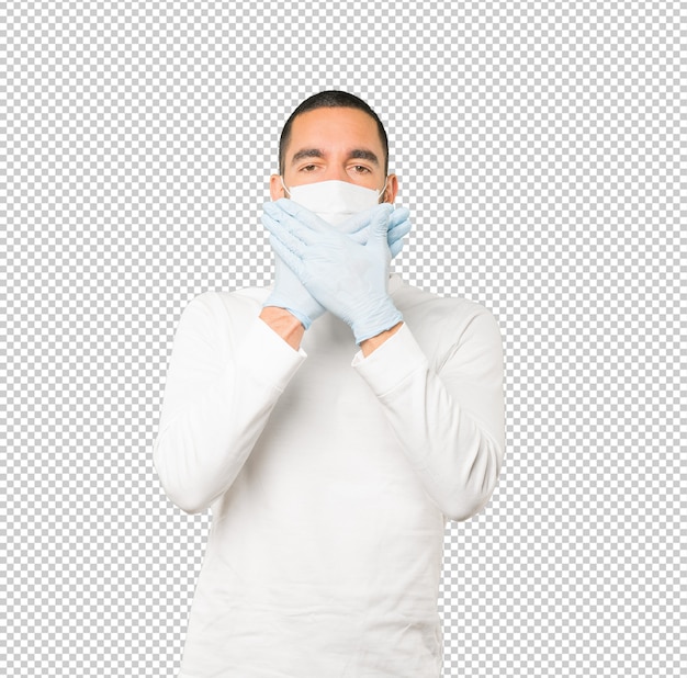 Coronavirus.Jeune homme faisant des concepts et portant un masque et des gants de protection