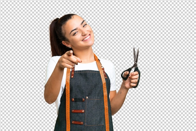 Une couturière sur un fond de clé chrome isolé pointant vers l'avant avec une expression heureuse