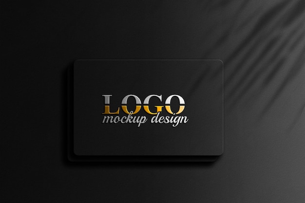 Diseño de maqueta de logotipo dorado 3d en textura de pared negra