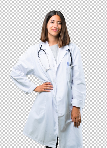 Docteur, femme, à, stéthoscope, poser bras, à, hanche, et, sourire