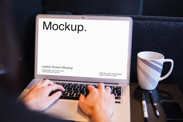 Ein mann schreibt auf einem laptop mit einem bildschirm-mockup