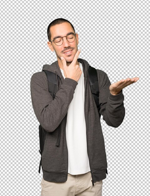 Estudiante dudoso sosteniendo algo con su mano