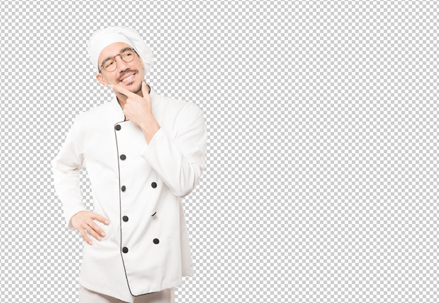 Feliz jovem chef fazendo um gesto de dúvida