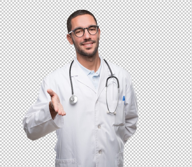 Feliz jovem médico fazendo um gesto de aperto de mão