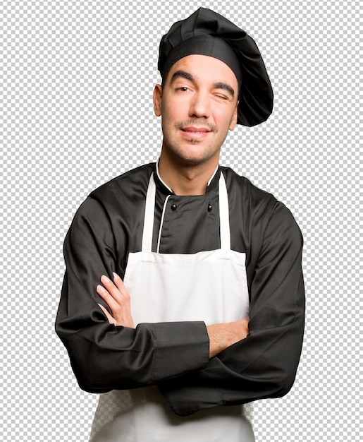 Feliz joven chef guiño un ojo