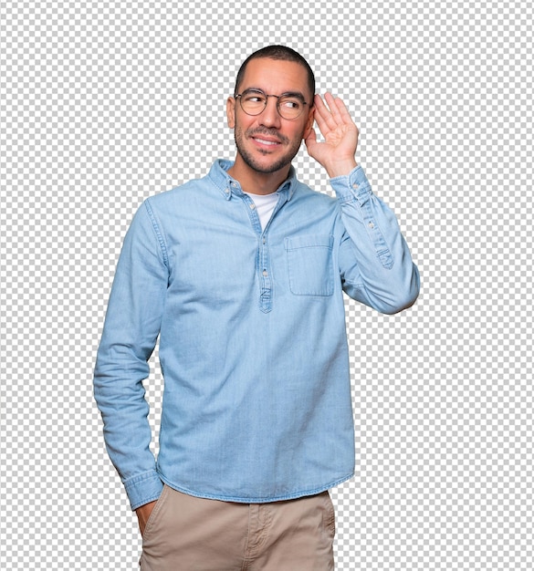 Feliz joven sonriendo y haciendo un gesto de intentar escuchar algo