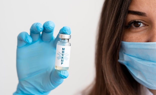 PSD femme avec masque médical tenant un receveur de vaccin