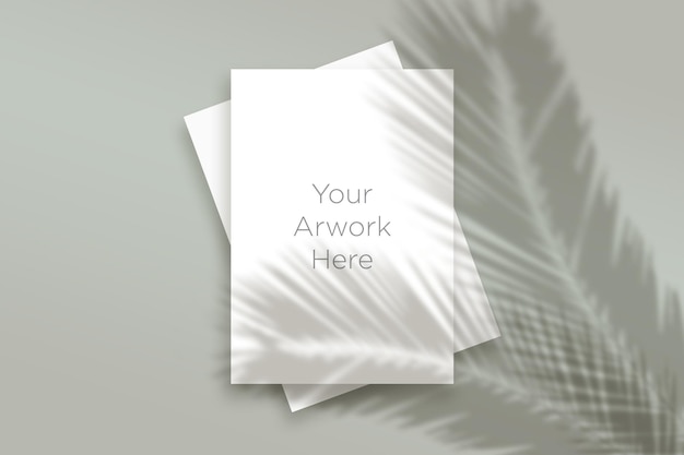 Flat Lay Two A4 Paper Mockup con sombra de hojas