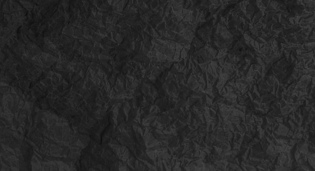 El fondo de papel negro roto y arrugado.