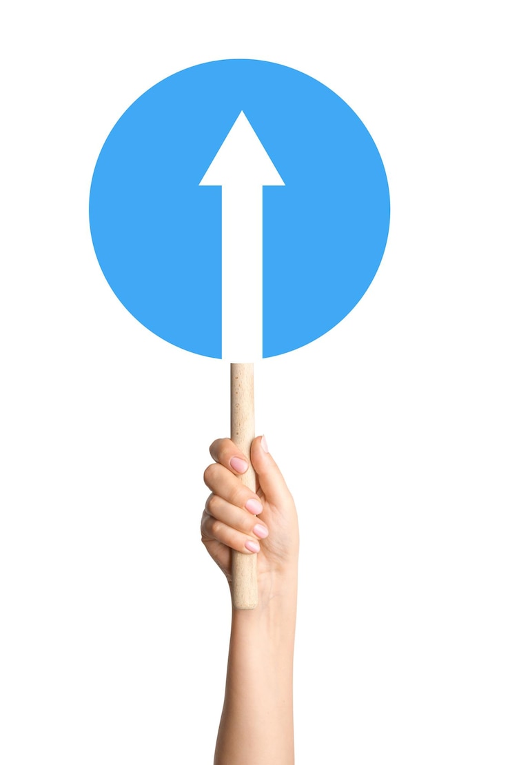 PSD forward arrow sign in a persons hand on a blank background great for navigation direction