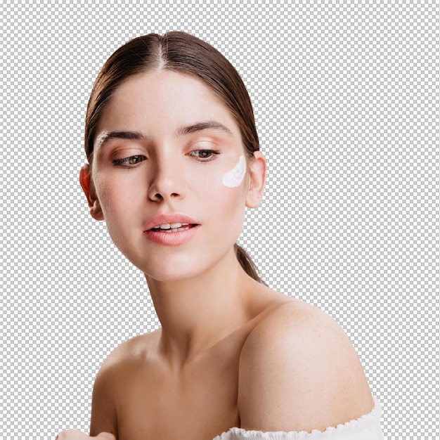 Fotografia de uma bela mulher de cabelos escuros com creme nutritivo no rosto