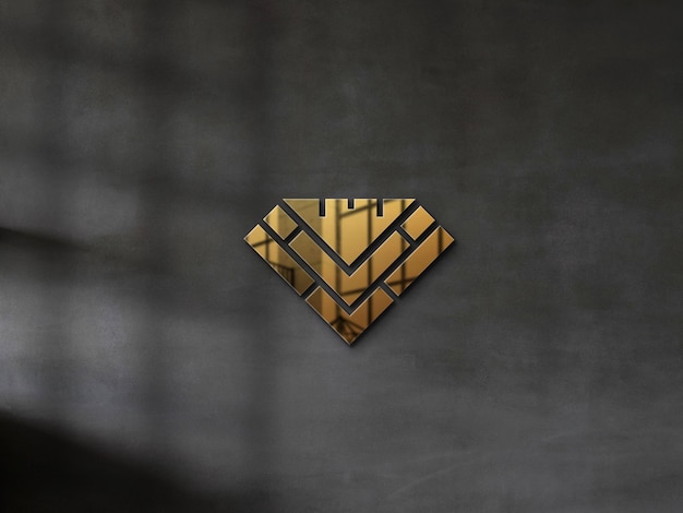 Geprägtes gold-logo-modell auf einer betonwand