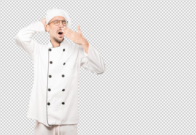 Gesto de bostezo de joven chef aburrido