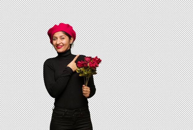 Giovane donna in giorno di San Valentino che punta al lato con il dito