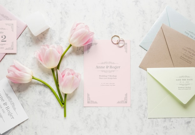 Gros plan de carte de mariage avec anneaux de mariage et tulipes