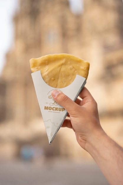 hand holding delicious crepe
