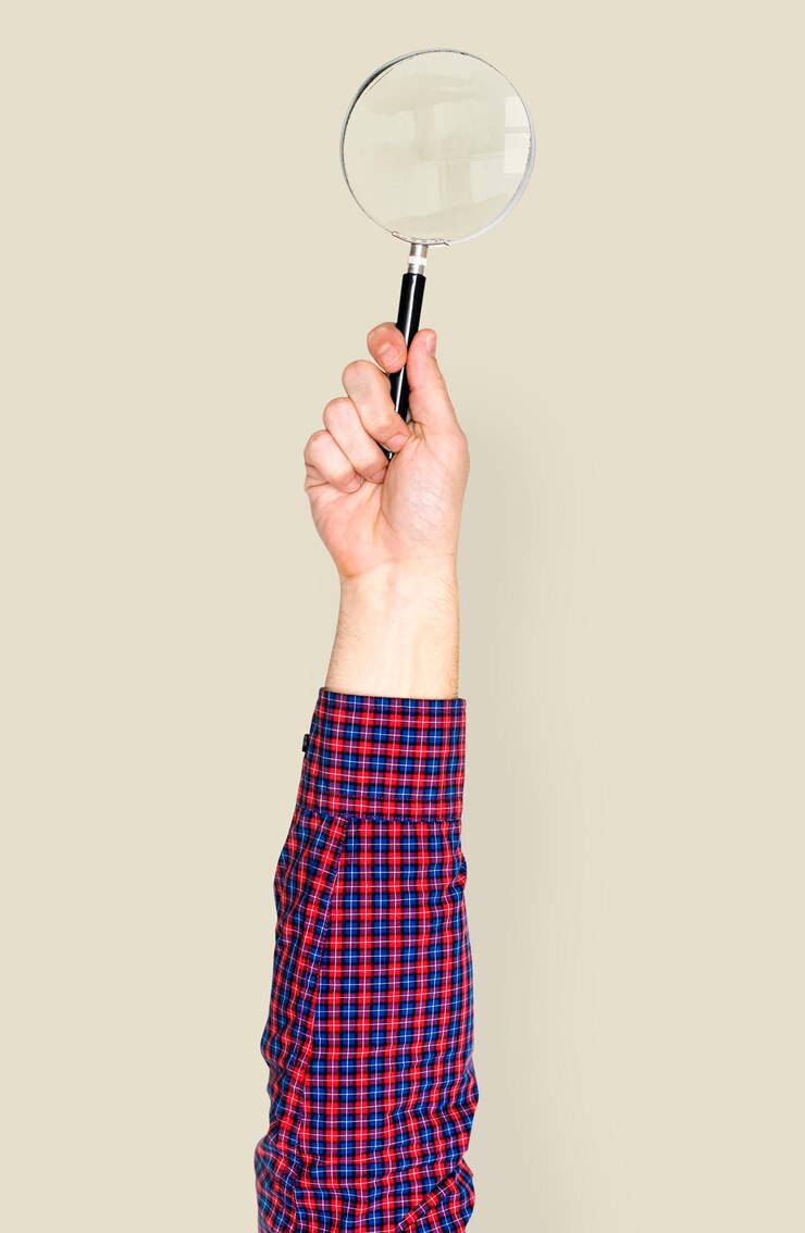 PSD hand holding magnifying glass