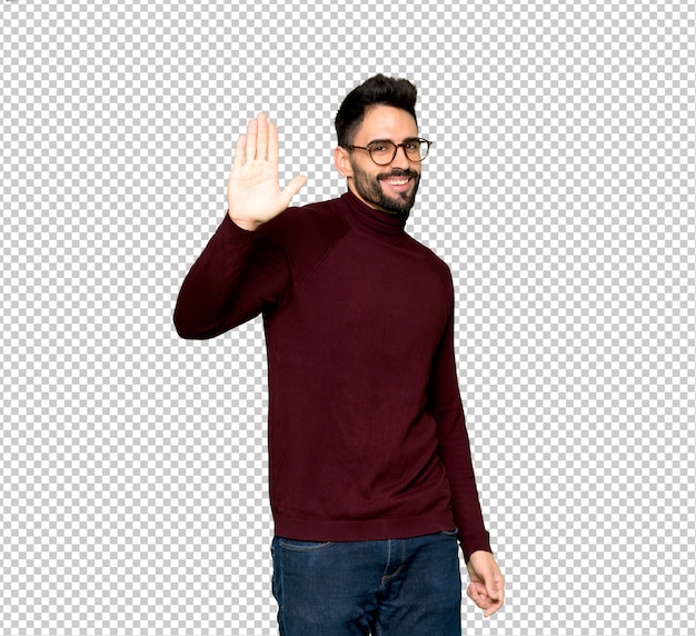 handsome man with glasses saluting with hand with happy expression