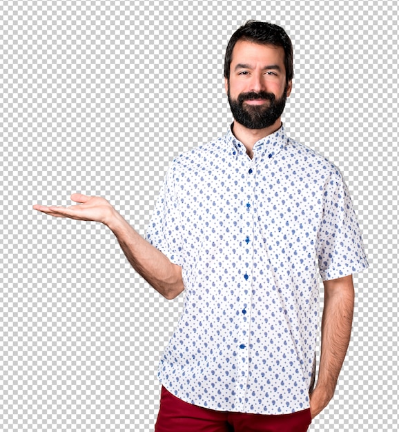 Hermoso morena hombre con barba sosteniendo algo