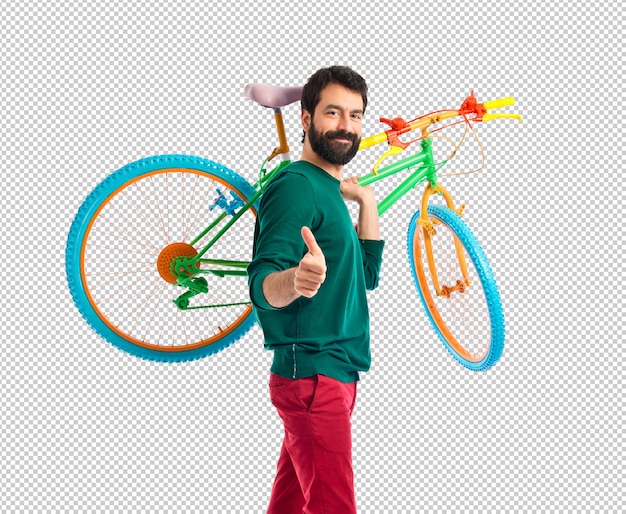 Hipster com o polegar para cima segurando uma bicicleta