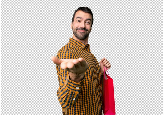 Hombre con bolsas de compra con copyspace imaginario en la palma para insertar un anuncio