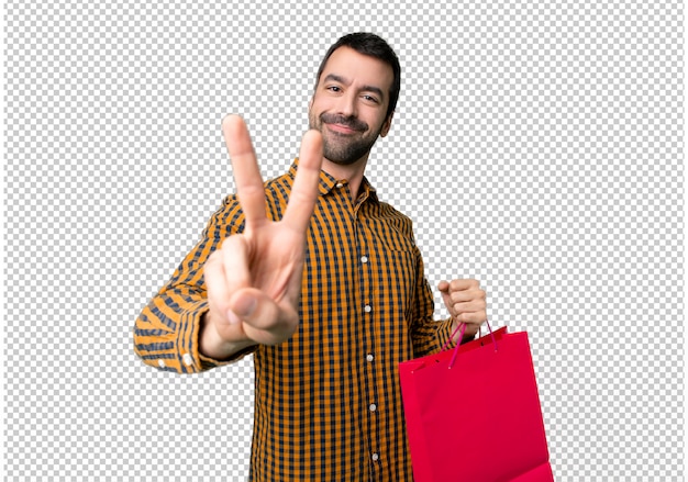 PSD hombre con bolsas de compras sonriendo y mostrando el signo de la victoria