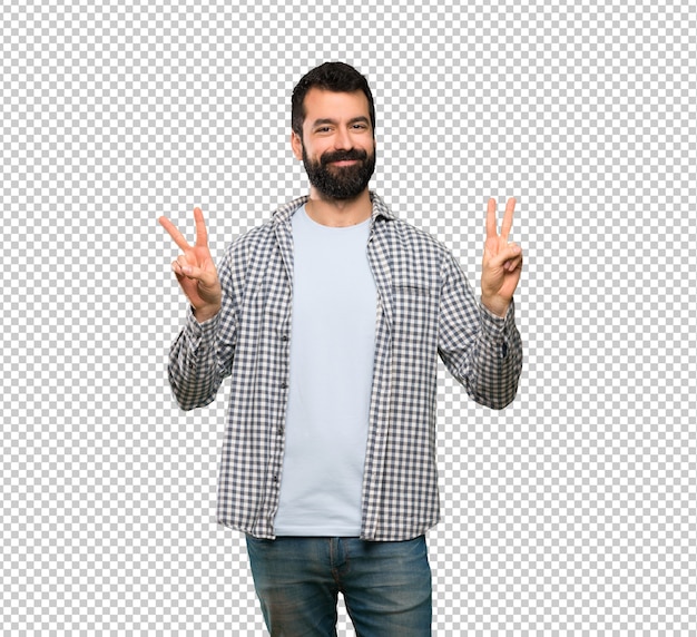 Hombre guapo con barba mostrando signo de victoria con ambas manos