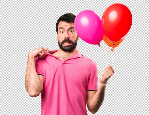 PSD hombre joven hermoso con la fiebre que sostiene los globos