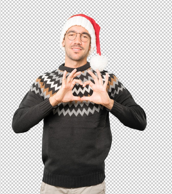 Hombre joven con un sombrero de navidad mientras gesticula aislado