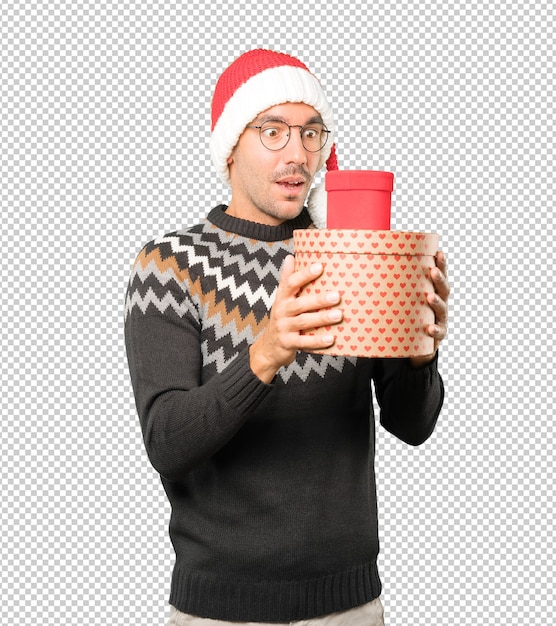 Hombre joven con un sombrero de Navidad mientras gesticula aislado