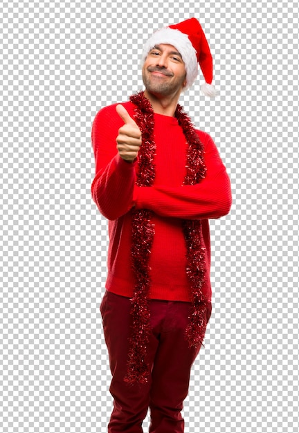 Hombre con ropa roja celebrando las vacaciones de navidad dando un pulgar hacia arriba gesto