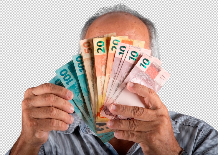 PSD hombre sosteniendo billetes de dinero brasileño frente a su cara png fondo transparente