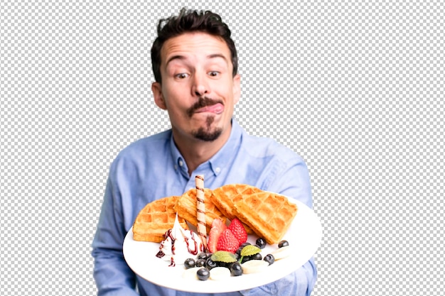 Homem adulto comendo waffles no café da manhã