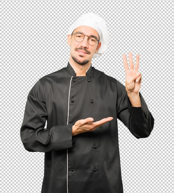 Jeune chef faisant un geste numéro trois