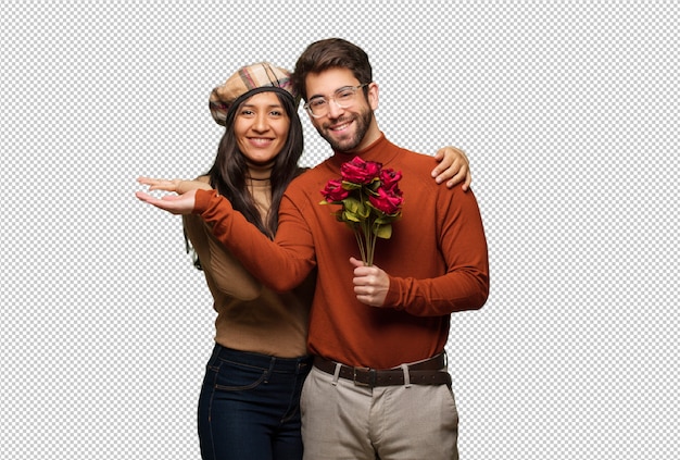 Jeune Couple En Saint Valentin Tenant Quelque Chose Avec La Main