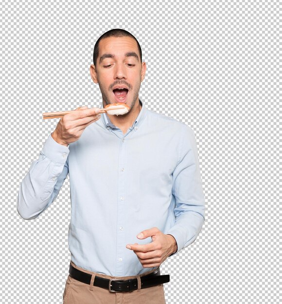 Jeune Homme à L'aide De Baguettes Pour Manger Des Sushis