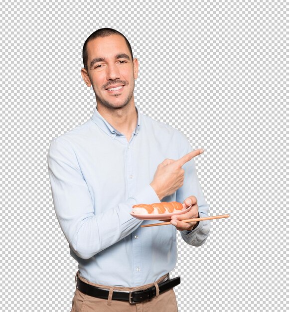 Jeune Homme à L'aide De Baguettes Pour Manger Des Sushis