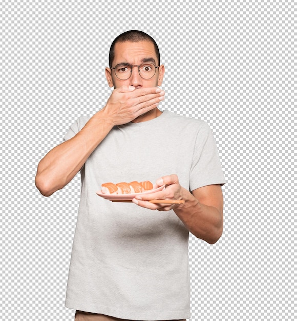 Jeune Homme à L'aide De Baguettes Pour Manger Des Sushis