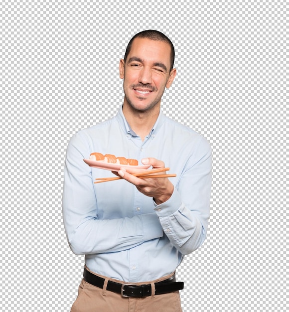 Jeune Homme à L'aide De Baguettes Pour Manger Des Sushis