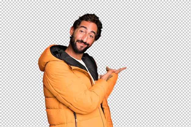 PSD jeune homme barbu et expressif fou concept froid et hiver et portant un anorak