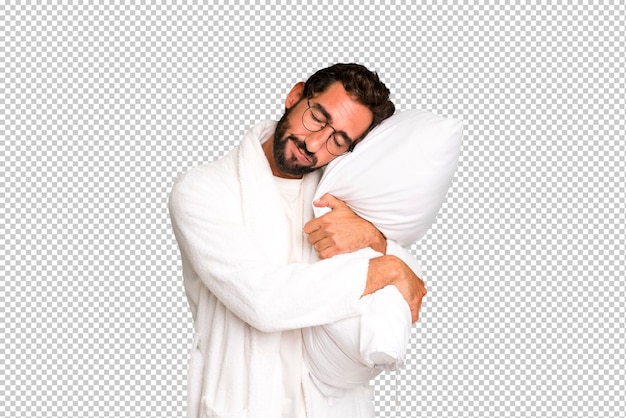 Jeune homme barbu fou et expressif portant un peignoir et un oreiller