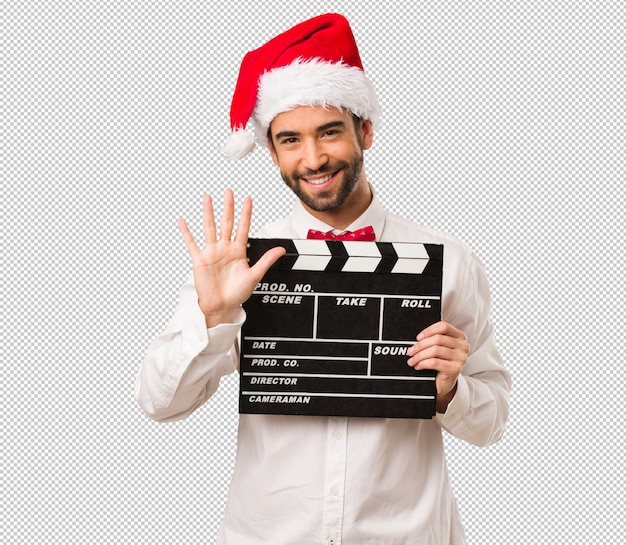 Jeune Homme Coiffé D'un Chapeau De Père Noël Le Jour De Noël