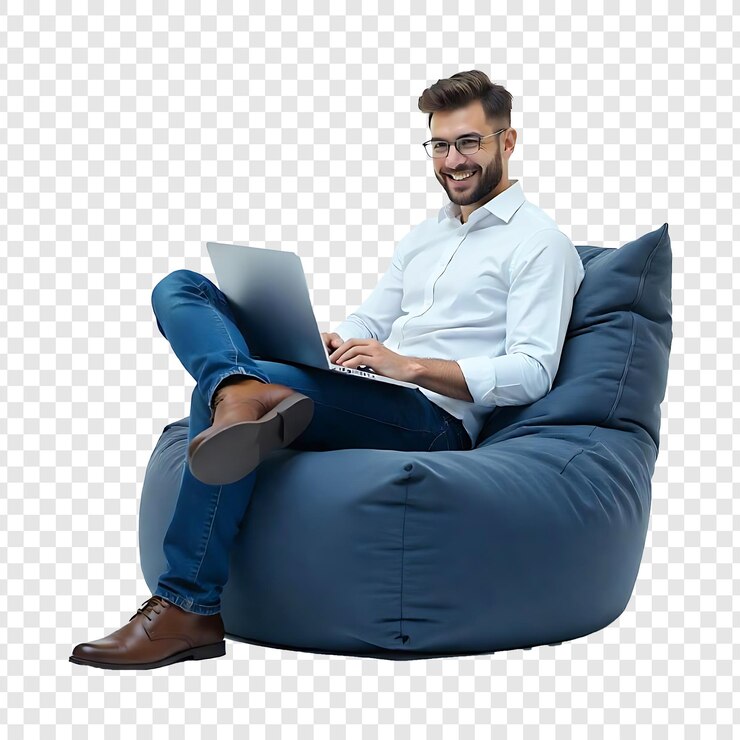 PSD un jeune homme heureux assis dans une chaise en sac en utilisant un nouvel ordinateur portable