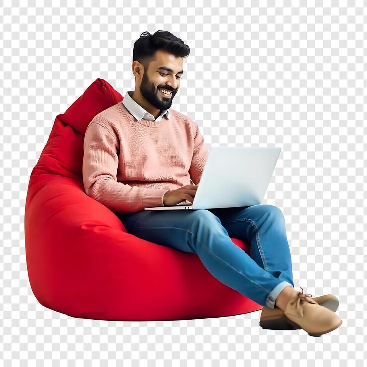 PSD un jeune homme heureux assis dans une chaise en sac en utilisant un nouvel ordinateur portable