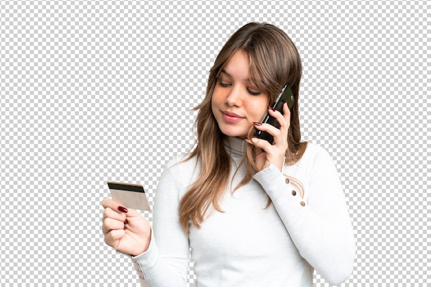 Jovem garota sobre isolado chroma chave de fundo comprando com o celular com um cartão de crédito