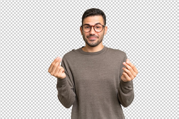 Jovem homem caucasiano bonito sobre fundo isolado fazendo dinheiro gesto